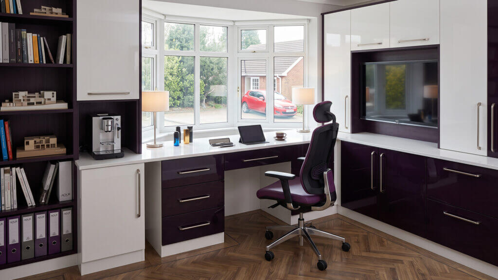 Fitted home study with a corner desk, white and aubergine units and bookshelves